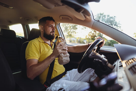 Danger on the Road. Man Drinking While Driving