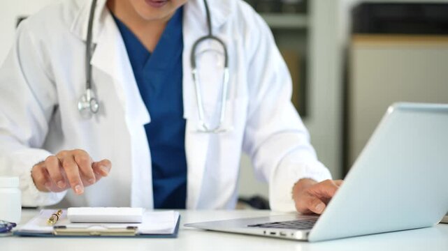 Doctor man use a service fee calculator to save money on health insurance, drug cost concept.