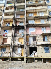 War damaged apartment building showing destruction aftermath with broken windows and structural damage representing conflict consequences and humanitarian crisis in urban area