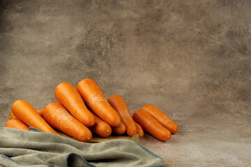 Lots of carrots on an abstract background. Vegetables in the form of carrots. There is space for text.