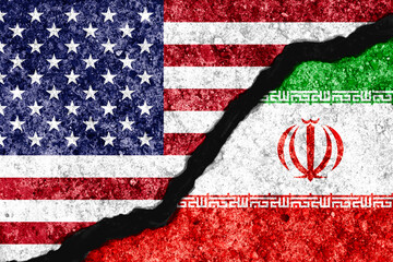 Concrete wall crack separate between USA flag and IRAN flag for conflict military war between United States of America and Iran concept.