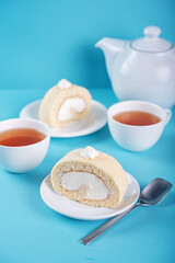 Vanilla cake roll with whipped cream filling in a plate