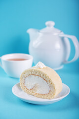 Vanilla cake roll with whipped cream filling in a plate