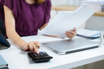 Business women are calculating daily expenses.