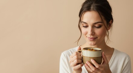 Young woman enjoying a warm beverage while smiling indoors  