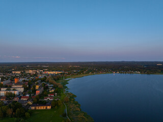 Aerial view of Võru, Estonia at sunset, featuring the serene Tamula Lake and surrounding...