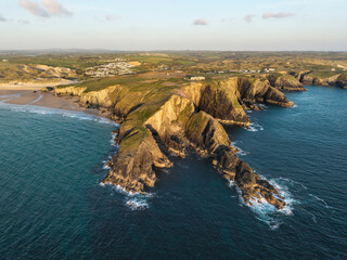 Beautiful aerial drone landscape image of Holywell Bay in Cornwall during colorful vibrant Summer sunset
