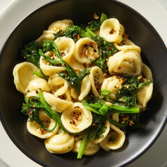 Elegant orecchiette pasta bowl with fresh greens and spicy seasoning creates a delightful culinary experience