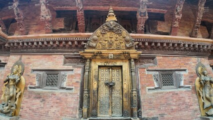 Fototapeta premium Golden-Plated Main Temple Door with Intricate Carvings in Bhaktapur Durbar Square, Nepal
