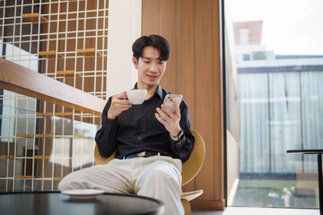 Confident male entrepreneur using smartphone while sitting in stylish cafe.