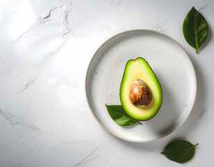 Minimalist Top-Down View of Sliced Hass Avocado on Plate with Leaves