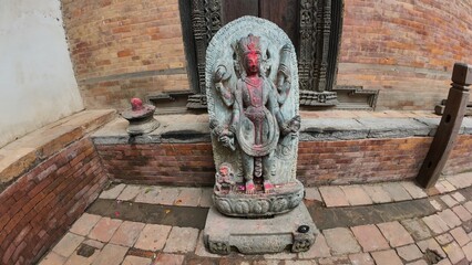 Hindu Deity Stone Sculpture in Front of Historic Temple at Bhaktapur Durbar Square, Nepal