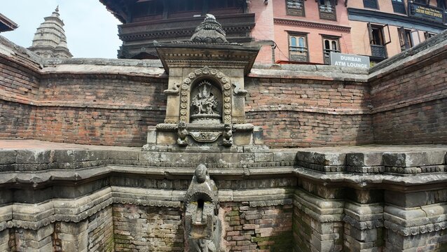 Traditional Stone Water Fountain with Hindu Shrine in Bhaktapur, Kathmandu Valley

