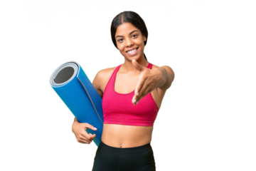 Young sport African American woman going to yoga classes while holding a mat over isolated background shaking hands for closing a good deal