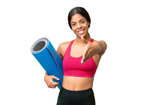 Young sport African American woman going to yoga classes while holding a mat over isolated background shaking hands for closing a good deal