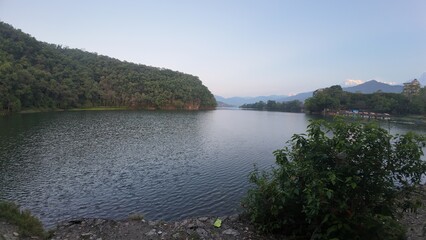 Tranquil Early Morning at Pokhara Lake: Serene Mountains and Calm Waters