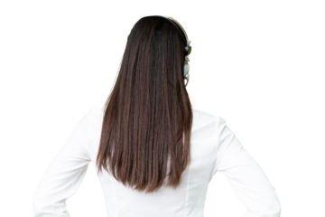 Telemarketer African American woman working with a headset over isolated chroma key background in back position