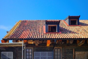 Restoration of a historic building with a tiled roof.