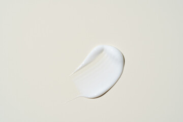 Smooth, glossy cream streak on muted beige, capturing its high-shine finish and rich hydration for...