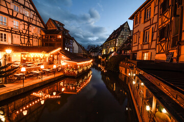 Eguisteim canals with typical houses at dusk