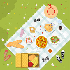 A top view of a summer picnic with various foods on green grass. Vector illustration in flat design style.