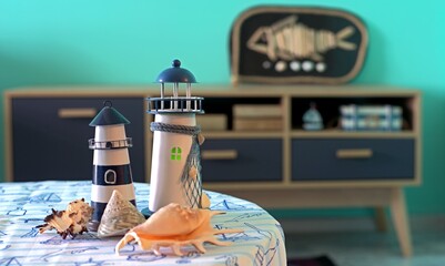 Lighthouses and shells on a table in a room decorated in a nautical style
