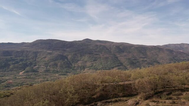 Aerial drone footage of Jerte Valley river, farmland and mountain landscape in Spain.