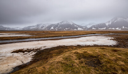 Icelandic landscape with mountains and meadow land covered in snow at snaefellsnes peninsula in...