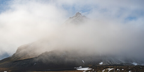 Icelandic landscape with mountains and meadow land covered in snow at snaefellsnes peninsula in...