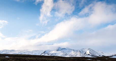 Icelandic landscape with mountains and meadow land covered in snow at snaefellsnes peninsula in...