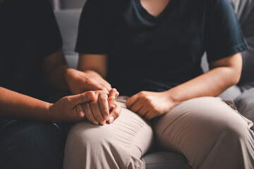 Hope and trust with crisis concept. Closeup, love and holding hands for support, comfort and care with grief, loss and empathy. people and family with compassion, sympathy and healing with bonding.