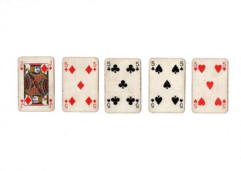 A poker hand of old grubby playing cards isolated on a white background.