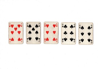 A poker hand of old grubby playing cards isolated on a white background.