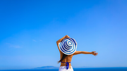 Happy moment freedom lifestyle Relaxation as fresh of summer with back view of young woman in hat  on the beach at Maldives