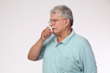 Portrait of  unhealthy Senior man with grey hair standing over isolated background feeling unwell...
