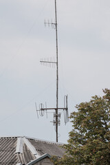 Rooftop TV Antennas Against Grey Sky: Vintage Television Receivers on Slate Roof, Communication...