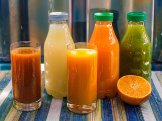 Variety of cold pressed fruit juices on counter
