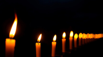 Row of Lit Candles with Bright Flames and Soft Glow Amidst Darkness Usage Backdrop