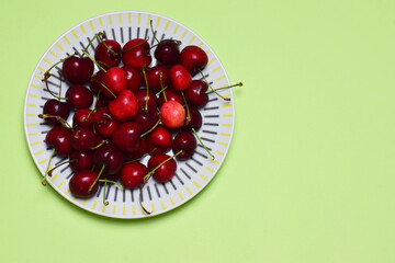 Cherries on a green background, a zenith view.