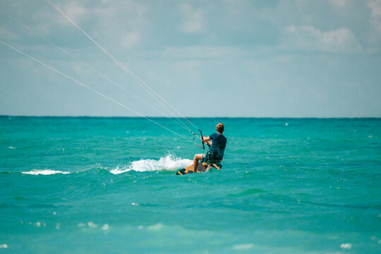 Kite surfing on blue water, kitesurfer with a board and harness, water sports scene