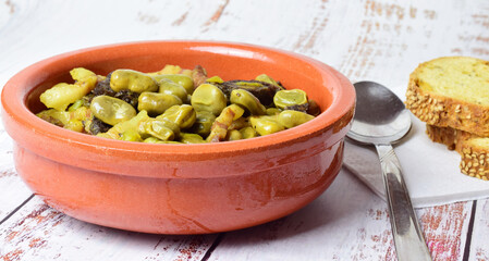 Baby broad beans with bacon and black pudding, typical of Spain.	
