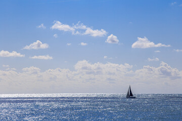 Sailboat is sailing in the ocean on a sunny day