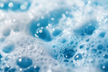 White soap foam with bubbles texture on blue background. Detergent foam bubble on water, soap sud.