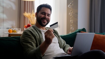 Happy smiling Caucasian man male guy shopper client customer homeowner using laptop typing computer...