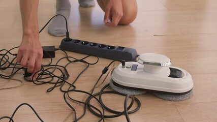 A man uses an automatic window cleaner for sparkling, crystal-clear glass and a spotless finish