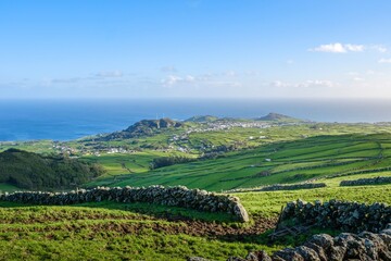Expansive View of Rolling Green Hills and Traditional Stone Walls Towards the Ocean on Terceira...
