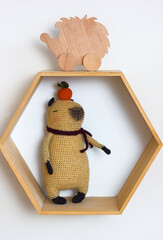 Trendy soft toy capybara crocheted in the interior of a children's room