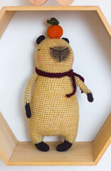 Trendy soft toy capybara crocheted in the interior of a children's room