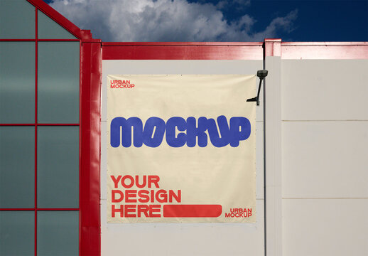 Poster Mockup for Storefront Ads. A blank canvas poster mockup is mounted on a storefront fa&ccedil;ade, ideal for marketing campaigns. The vibrant structure complements creative designs.