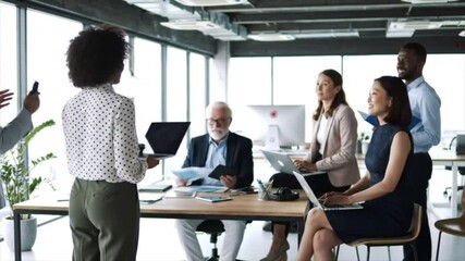 A diverse group of professionals engages in a collaborative discussion in a bright, modern office space. The team focuses on ideas and strategies to enhance their workflow